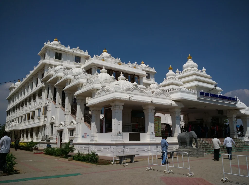 White ISKCON Temple building in Chennai under a blue sky